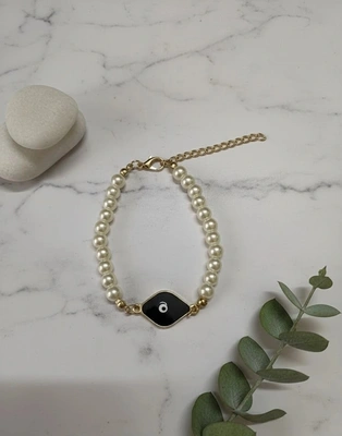 Elegant Pearl Evil Eye Bracelet with Black Enamel Charm