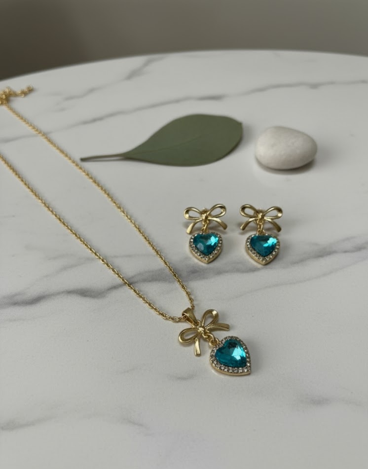 Dainty Gold Ribbon Stud Earrings with Aquamarine Heart Detail